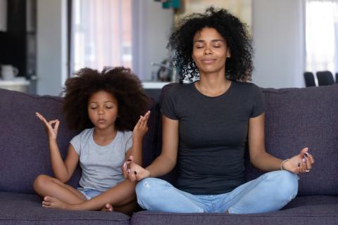 mother and daughter meditating together