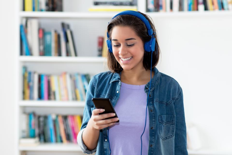 Woman listening to podcast on headphones